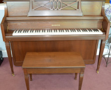 Samick console piano in stylish walnut cabinet